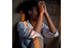 Woman is depressed sitting on the floor